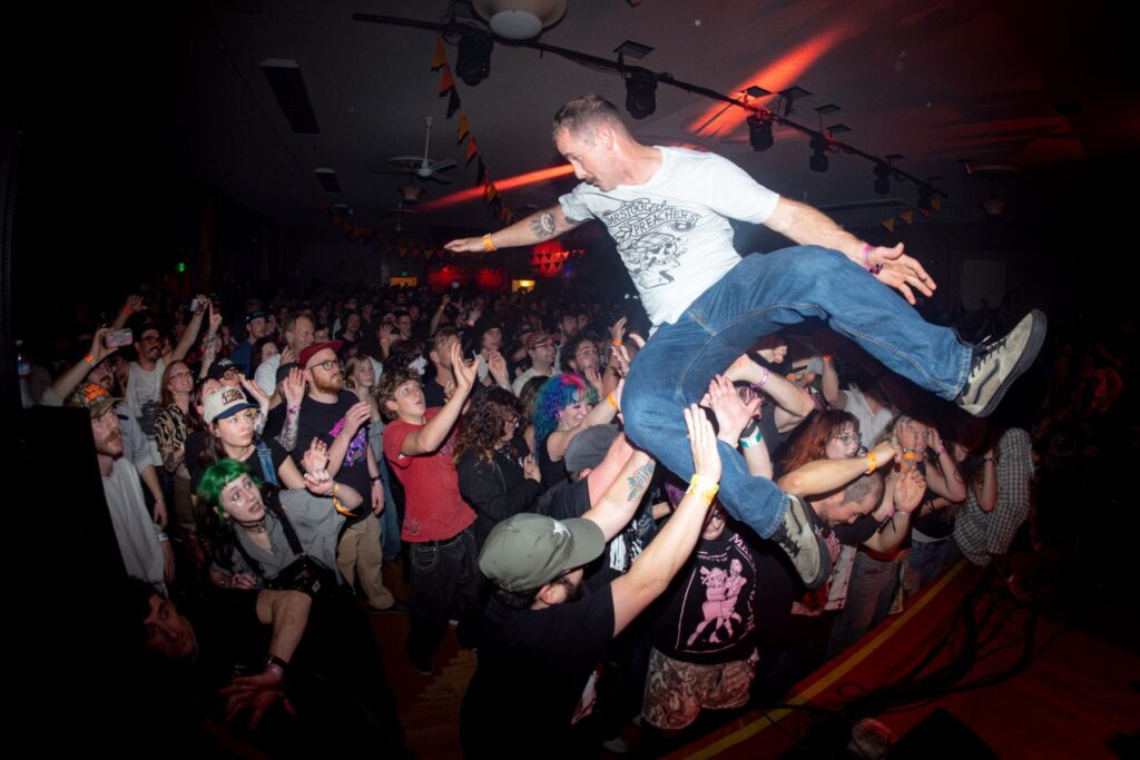 Stage diver caught mid-air over the crowd at The Shrine