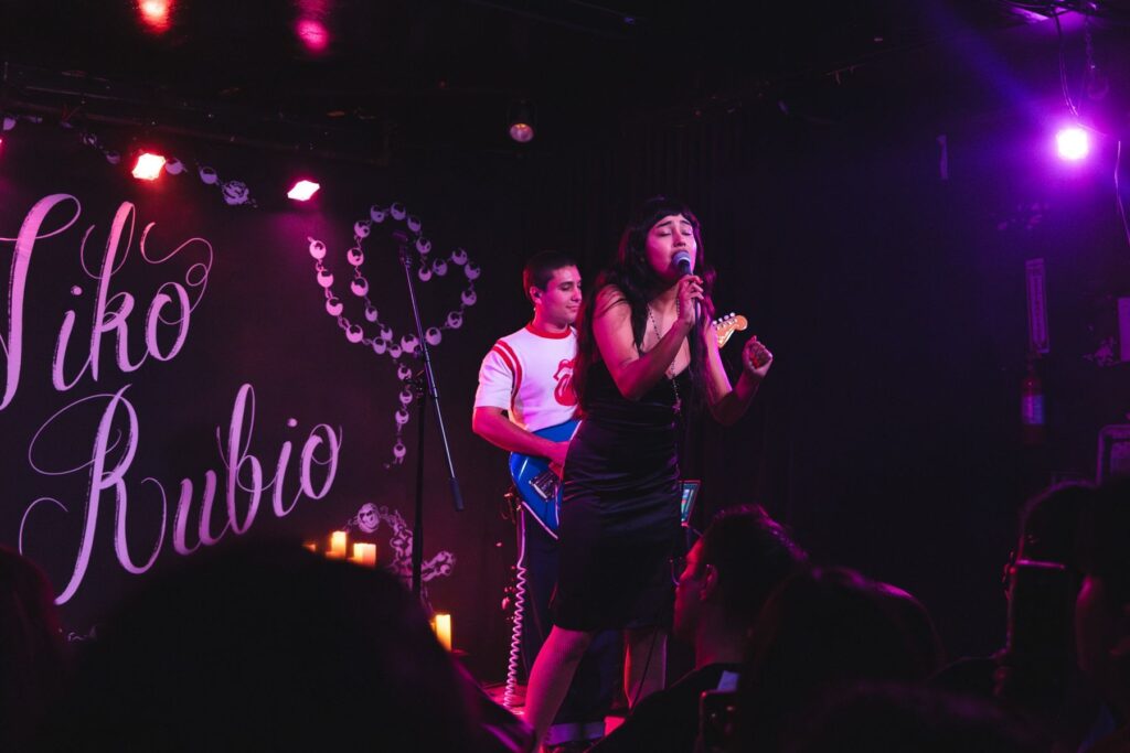 Niko Rubio and her band performing under pink stage lights at Beat Kitchen, Chicago