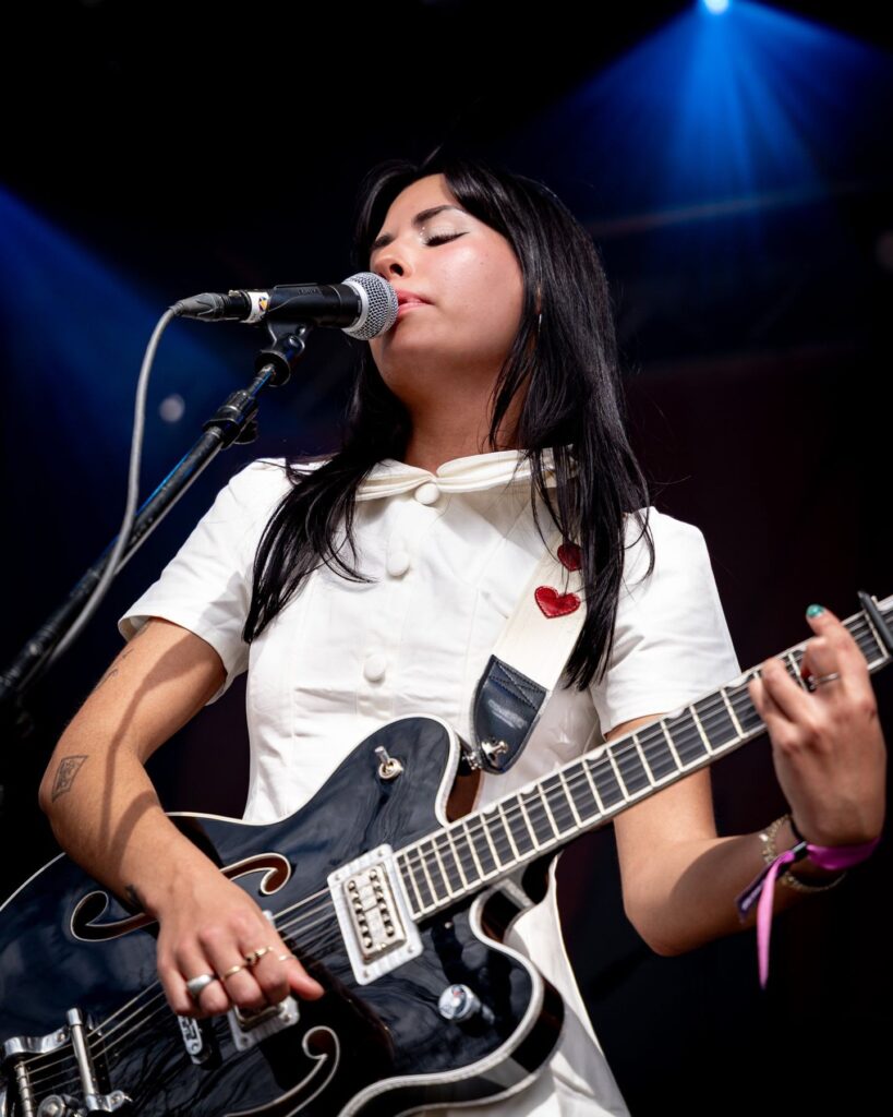 Guitarist singing into the microphone at Treefort Music Festival in Boise