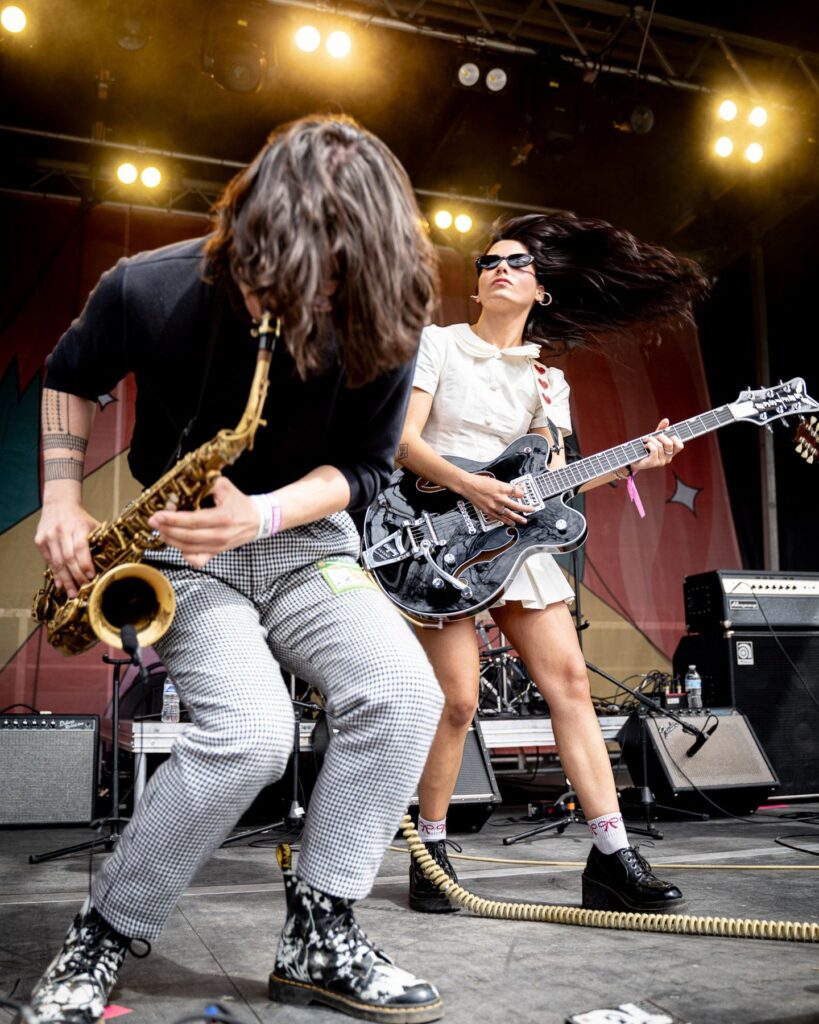 Saxophonist and guitarist performing together on the outdoor stage at Treefort Music Festival